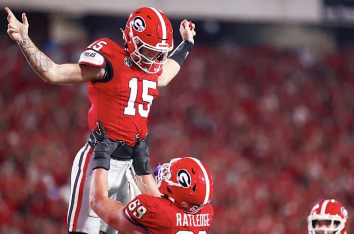 Georgia quarterback Carson Beck (15) is hoisted into the air by Georgia offensive guard Tate Ratledge (69) after scoring a touchdown versus UAB on Sept. 23, 2023 (Tony Walsh / UGAAA).
